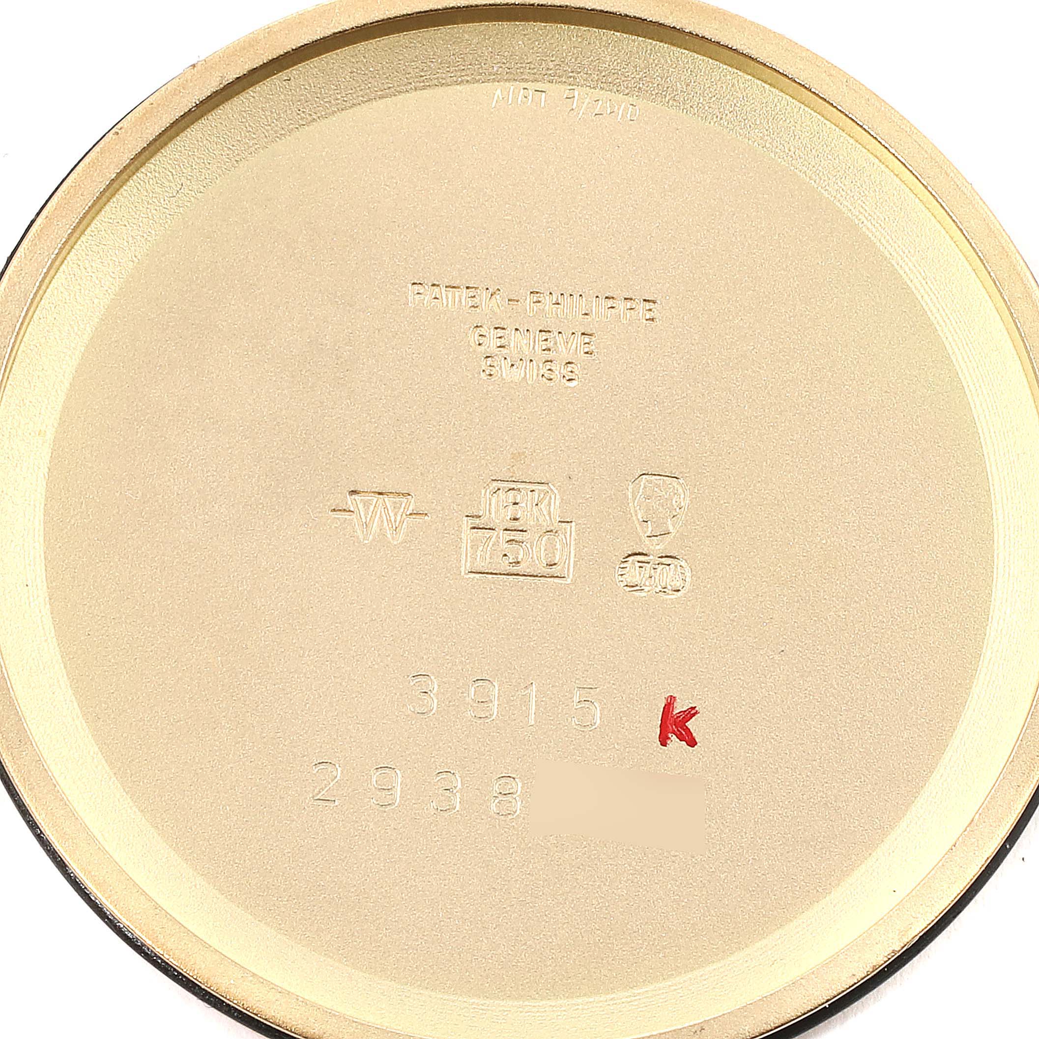 This image shows the inside case back of a Patek Philippe Calatrava 3915J Men's Yellow Gold Silver Dial 3915J Men's Yellow Gold Silver Dial watch, displaying hallmarks and serial numbers.