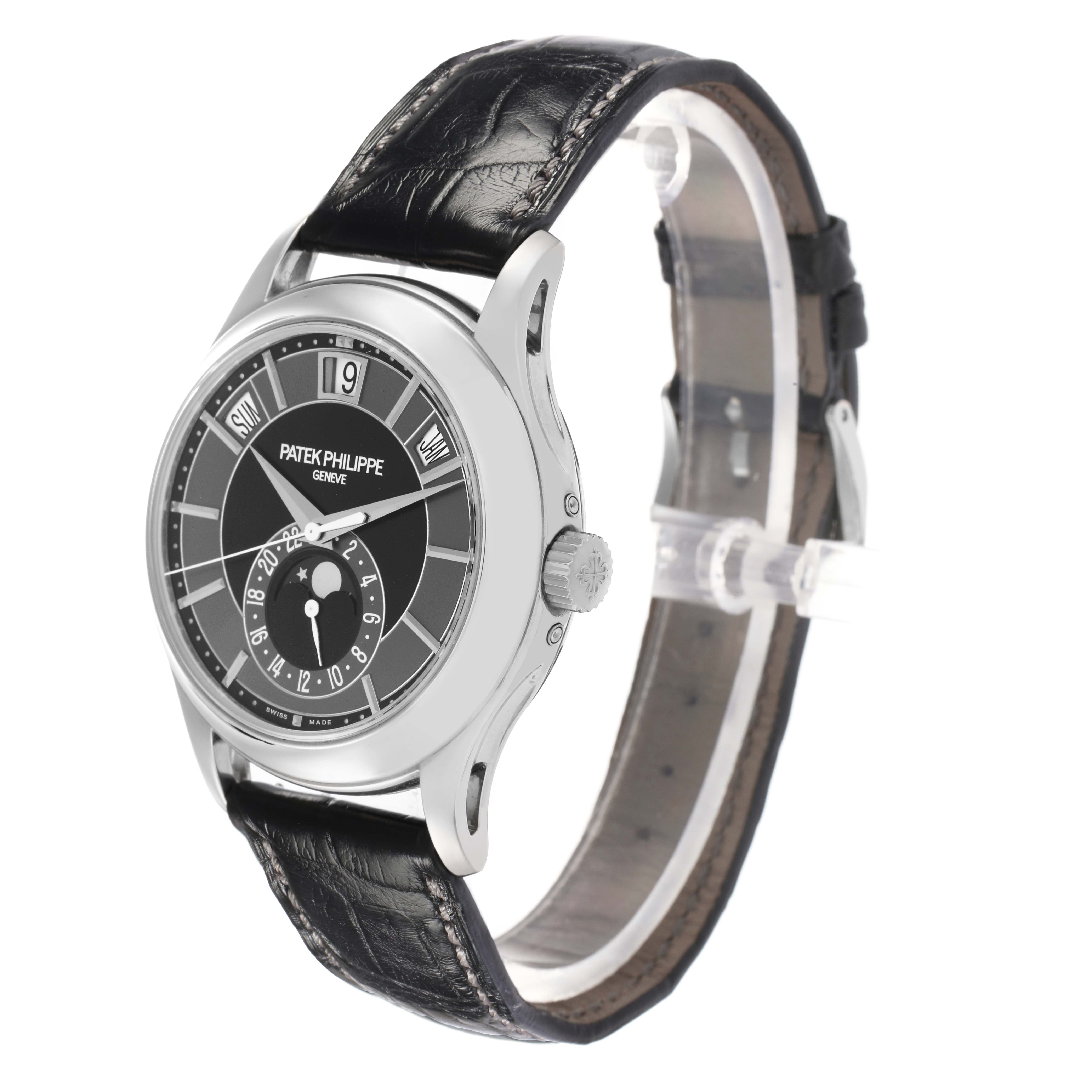 The image shows a Patek Philippe Complications 5205 Men
s White Gold Black Dial watch at a front-side angle, highlighting the face, case, crown, and leather strap.