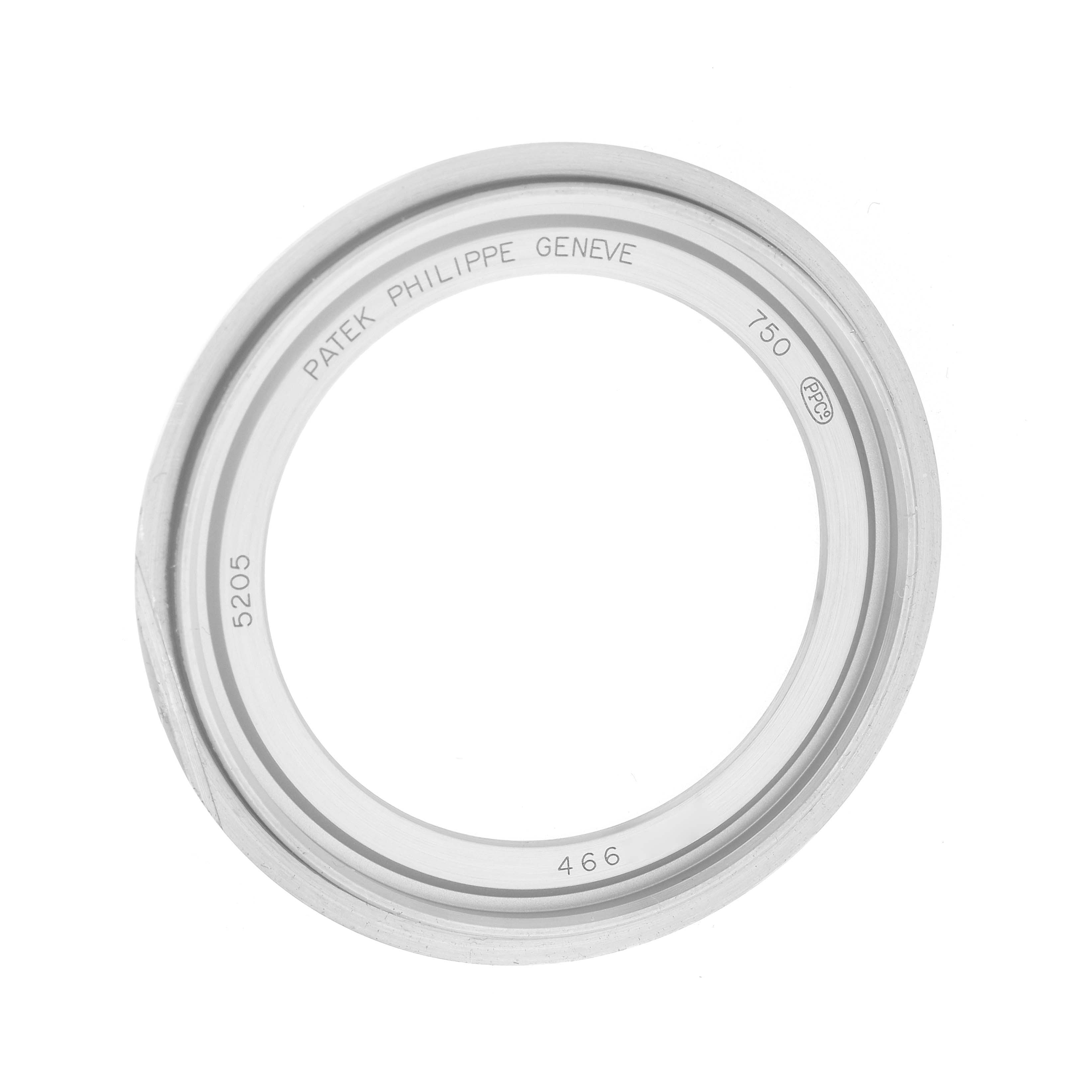 The image shows the bezel of a Patek Philippe Complications 5205 Men
s White Gold Black Dial watch, model 5205, angled from above.