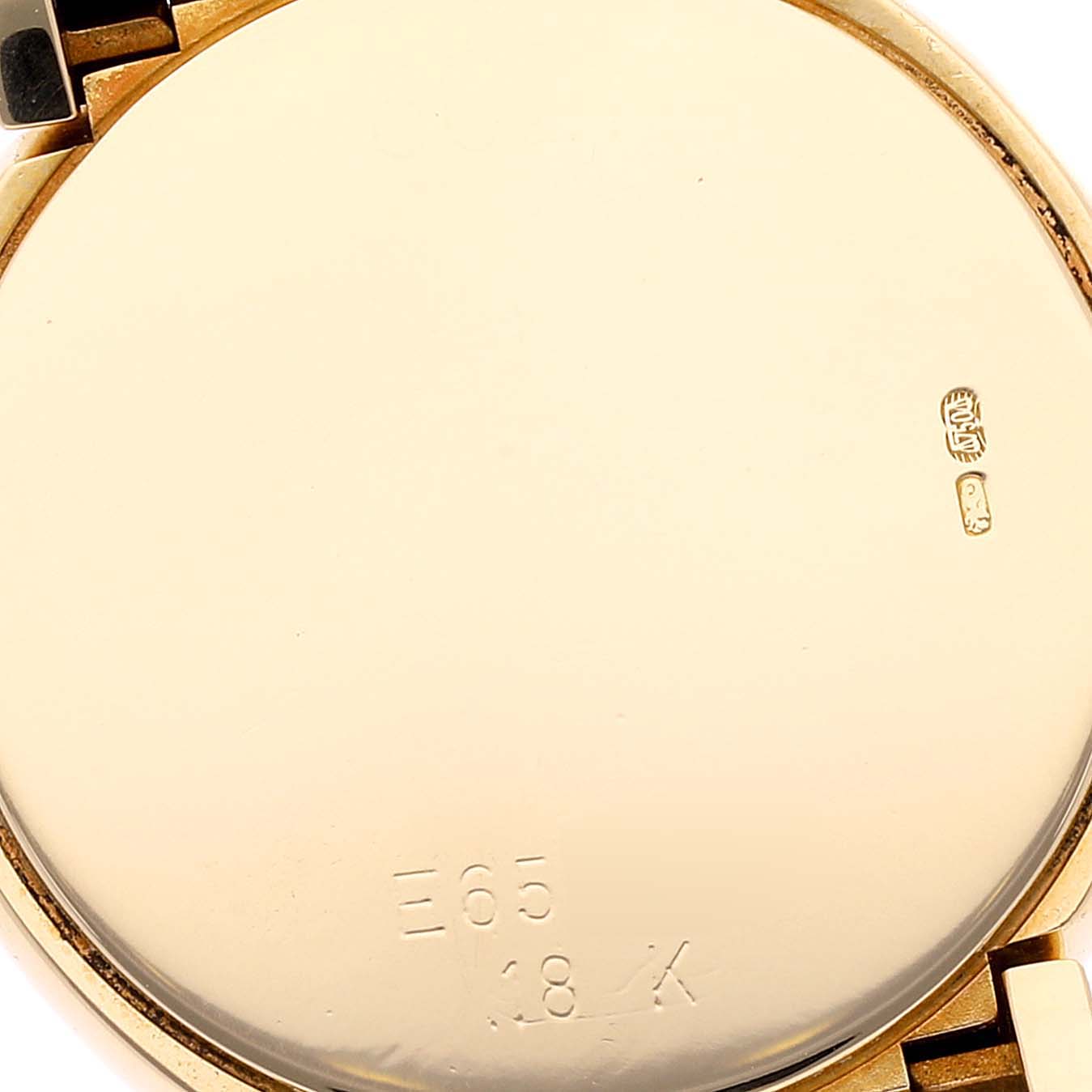This image shows the back of a Rolex Cellini 6621 Women's Yellow Gold Champagne Dial 6621 Women's Yellow Gold Champagne Dial watch, highlighting its case markings and 18K gold hallmark.