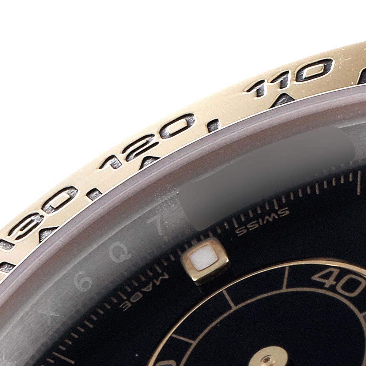 The image shows a close-up angle of the bezel and part of the dial of a Rolex Daytona 116503 Men
s Steel and Gold (two tone) Black Dial 116503 Men
s Steel and Gold (two tone) Black Dial watch.