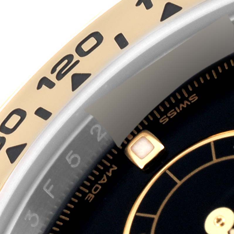 This close-up shows the bezel and part of the dial of a Rolex Daytona 116503 Men
s Steel and Gold (two tone) Black Dial 116503 Men
s Steel and Gold (two tone) Black Dial watch.