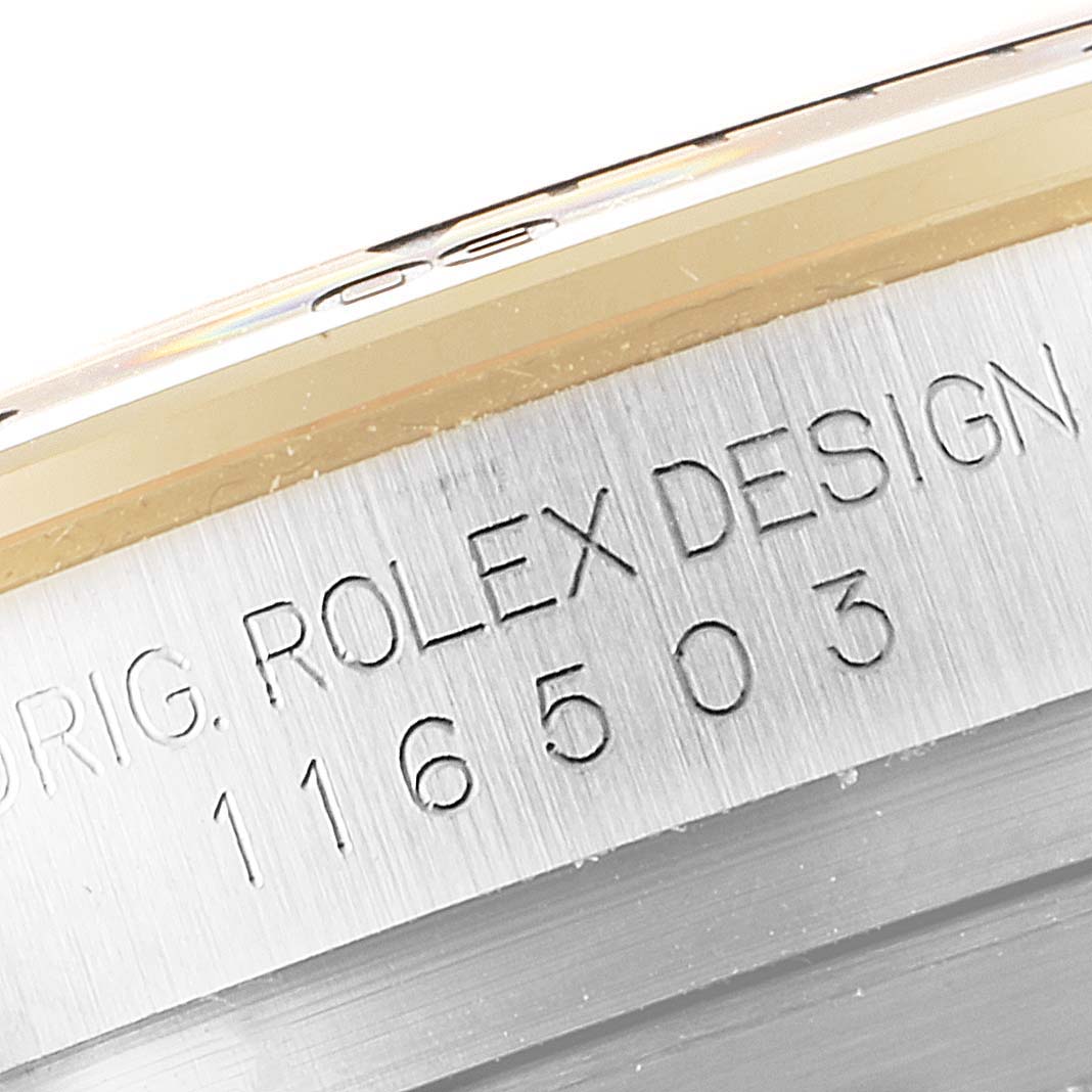 The image shows a close-up of the case edge of a Rolex Daytona 116503 Men
s Steel and Gold (two tone) Champagne Dial 116503 Men
s Steel and Gold (two tone) Champagne Dial watch, focusing on the serial and model number engraving.