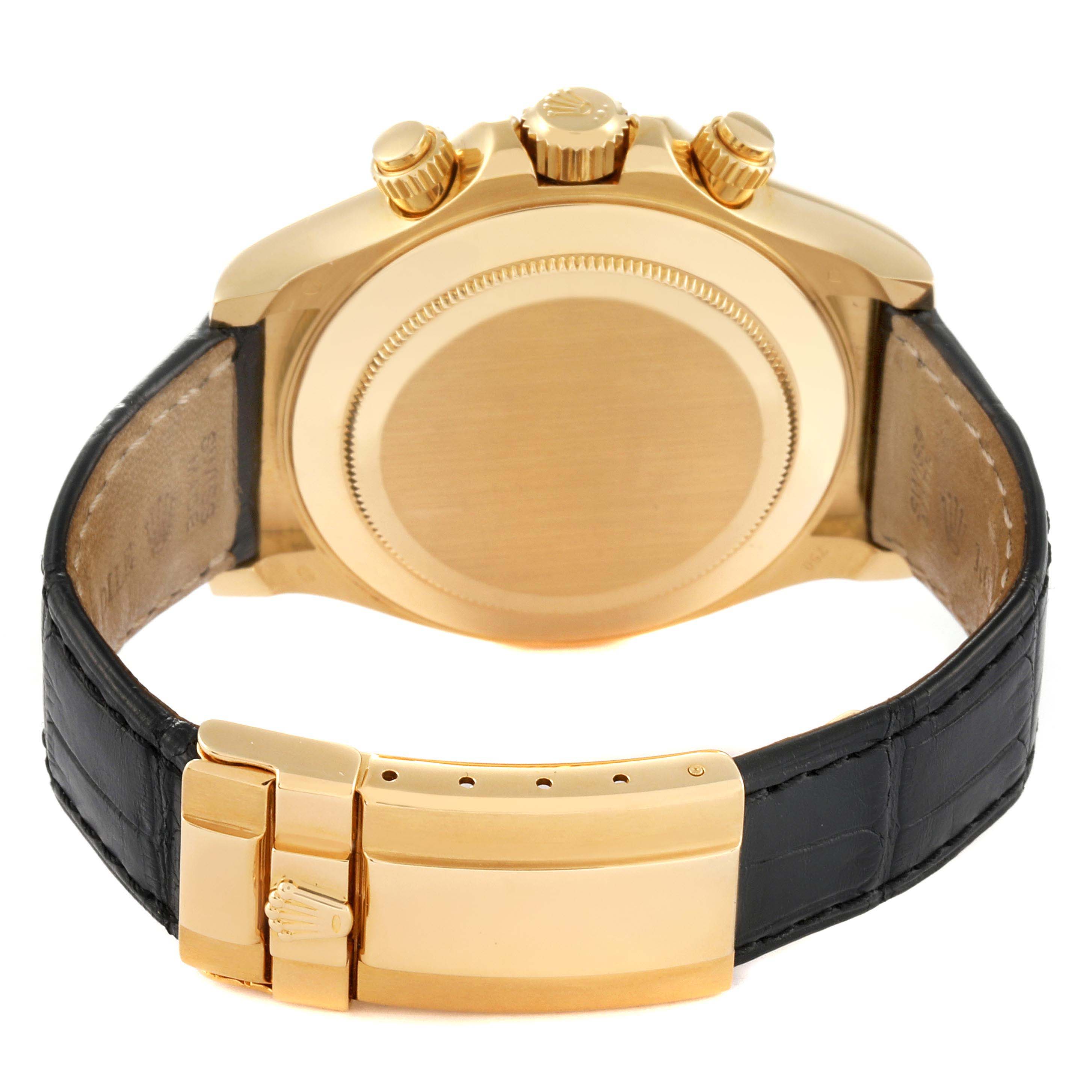 The image shows the back of a Rolex Daytona 116518 Men
s Yellow Gold Blue Dial 116518 Men
s Yellow Gold Blue Dial watch, highlighting the case back and the leather strap with a gold clasp.