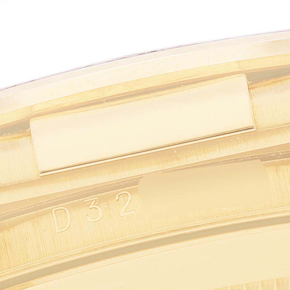 This image shows a partial close-up of the bezel with some serial engraving on the Rolex Daytona 116518 Men
s Yellow Gold Blue Dial 116518 Men
s Yellow Gold Blue Dial watch.