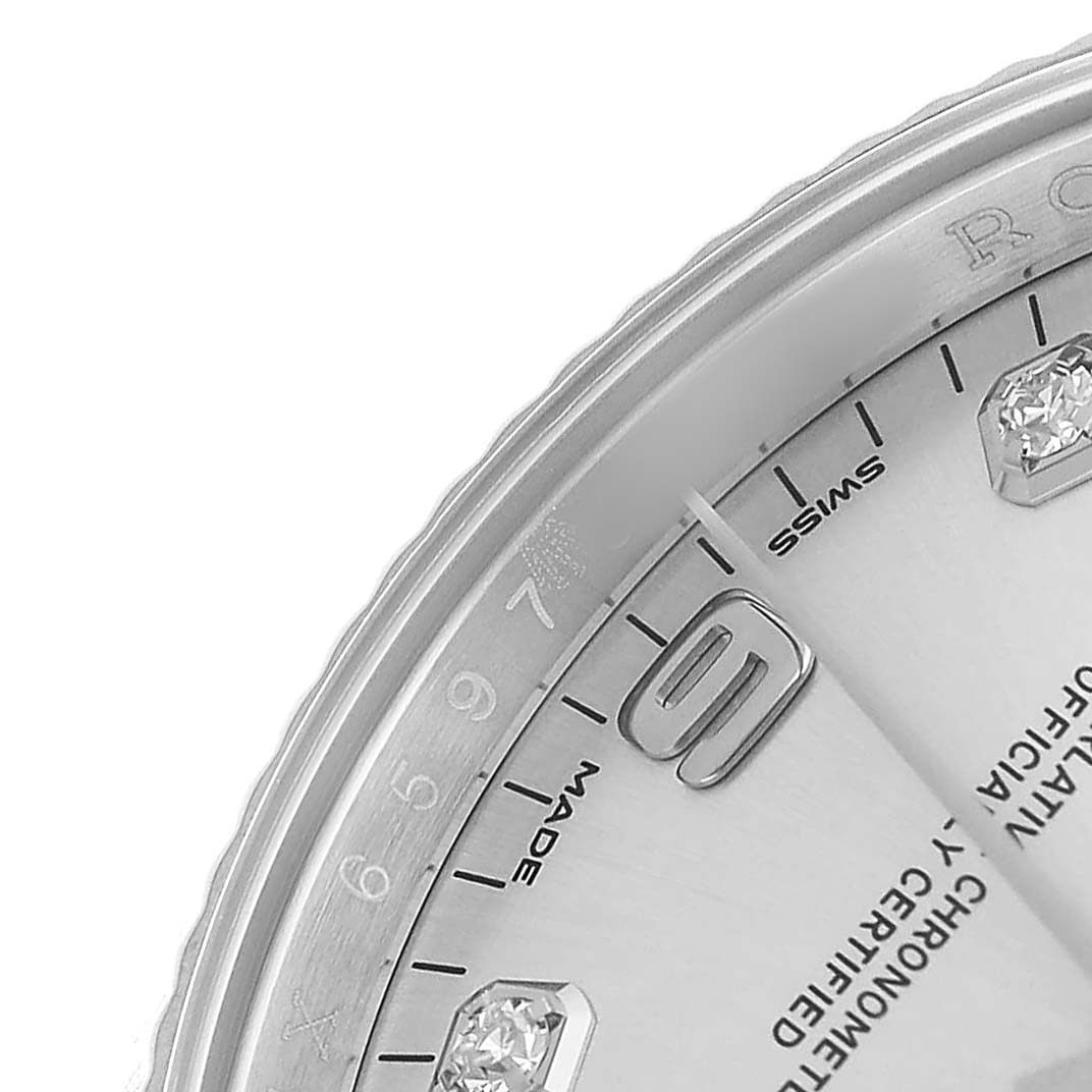 The image shows a close-up of the dial and part of the bezel, focusing on the hour markers and inscriptions of the Rolex Date 115234 Men's Stainless Steel Silver Dial model.