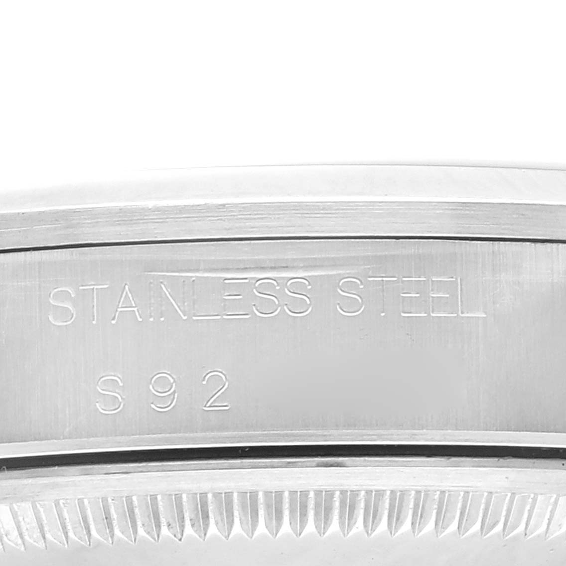 The image shows a close-up of the stainless steel case back of a Rolex Date 15200 Men's Stainless Steel Blue Dial 15200 Men's Stainless Steel Blue Dial model watch, with engraving details visible.