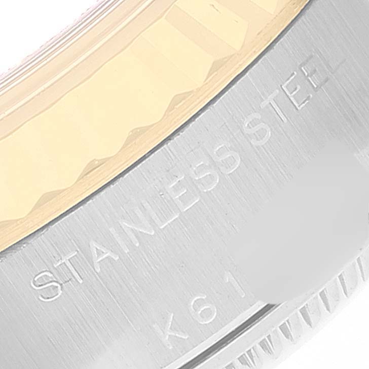 The image shows a close-up of the case back and the edge of the bezel of a Rolex Datejust 79173 Women's Steel and Gold (two tone) Beige Dial 79173 Women's Steel and Gold (two tone) Beige Dial.