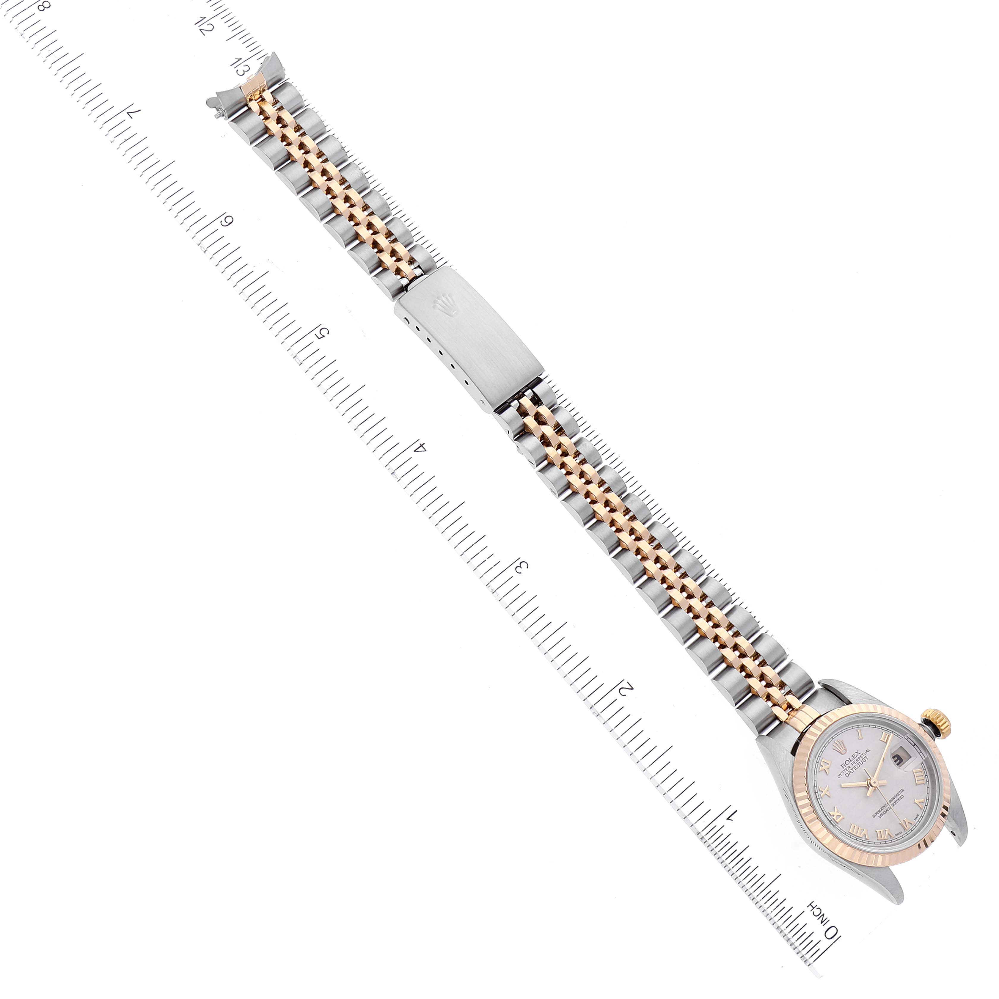 The image shows a Rolex Datejust 79173 Women's Steel and Gold (two tone) Beige Dial 79173 Women's Steel and Gold (two tone) Beige Dial watch laid flat with a two-tone bracelet, bezel, and part of a measuring ruler.
