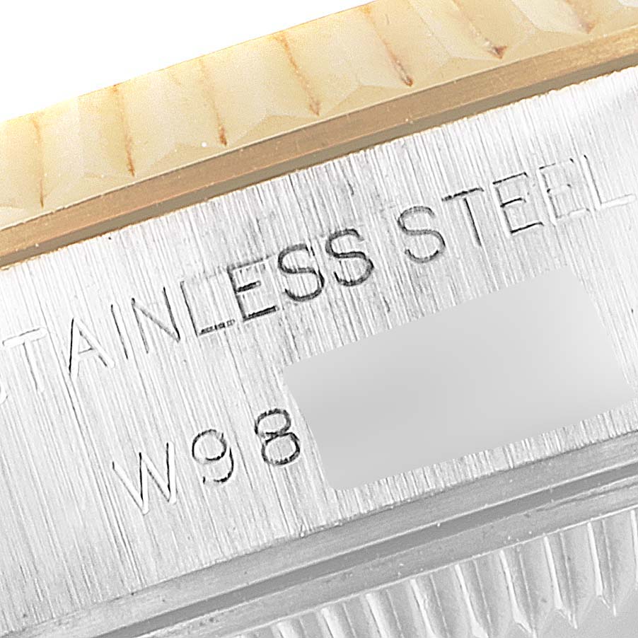 This close-up image shows the engraved "STAINLESS STEEL" marking on the side of the casing of a Rolex Datejust 69173 Women's Steel and Gold (two tone) Champagne Dial 69173 Women's Steel and Gold (two tone) Champagne Dial model watch.