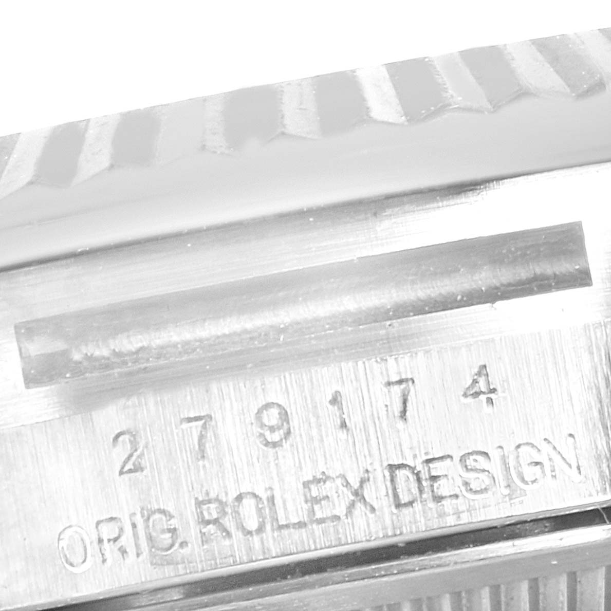 This image shows a close-up of the serial number and "ORIG. ROLEX DESIGN" engraving on the side of a Rolex Datejust 279174 Women's Stainless Steel Brown Dial 279174 Women's Stainless Steel Brown Dial watch case.