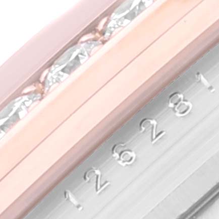 This is a close-up of the serial number engraving and part of the bezel on a Rolex Datejust 126281 Men's Steel and Gold (two tone) Mother of Pearl Dial 126281 Men's Steel and Gold (two tone) Mother of Pearl Dial watch.