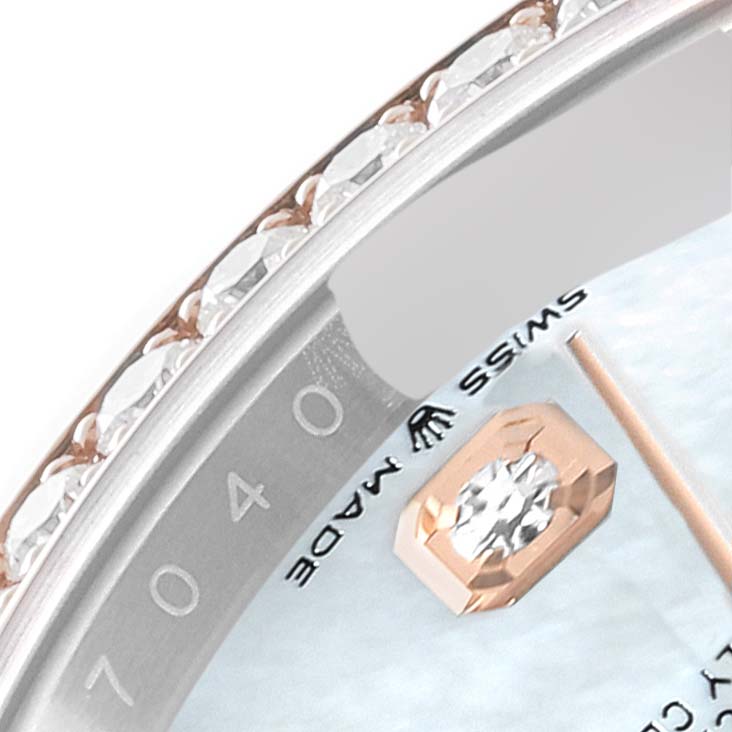 This image shows a close-up of the bezel and part of the dial of the Rolex Datejust 126281 Men's Steel and Gold (two tone) Mother of Pearl Dial 126281 Men's Steel and Gold (two tone) Mother of Pearl Dial watch, including diamond accents and the "SWISS MADE" text.