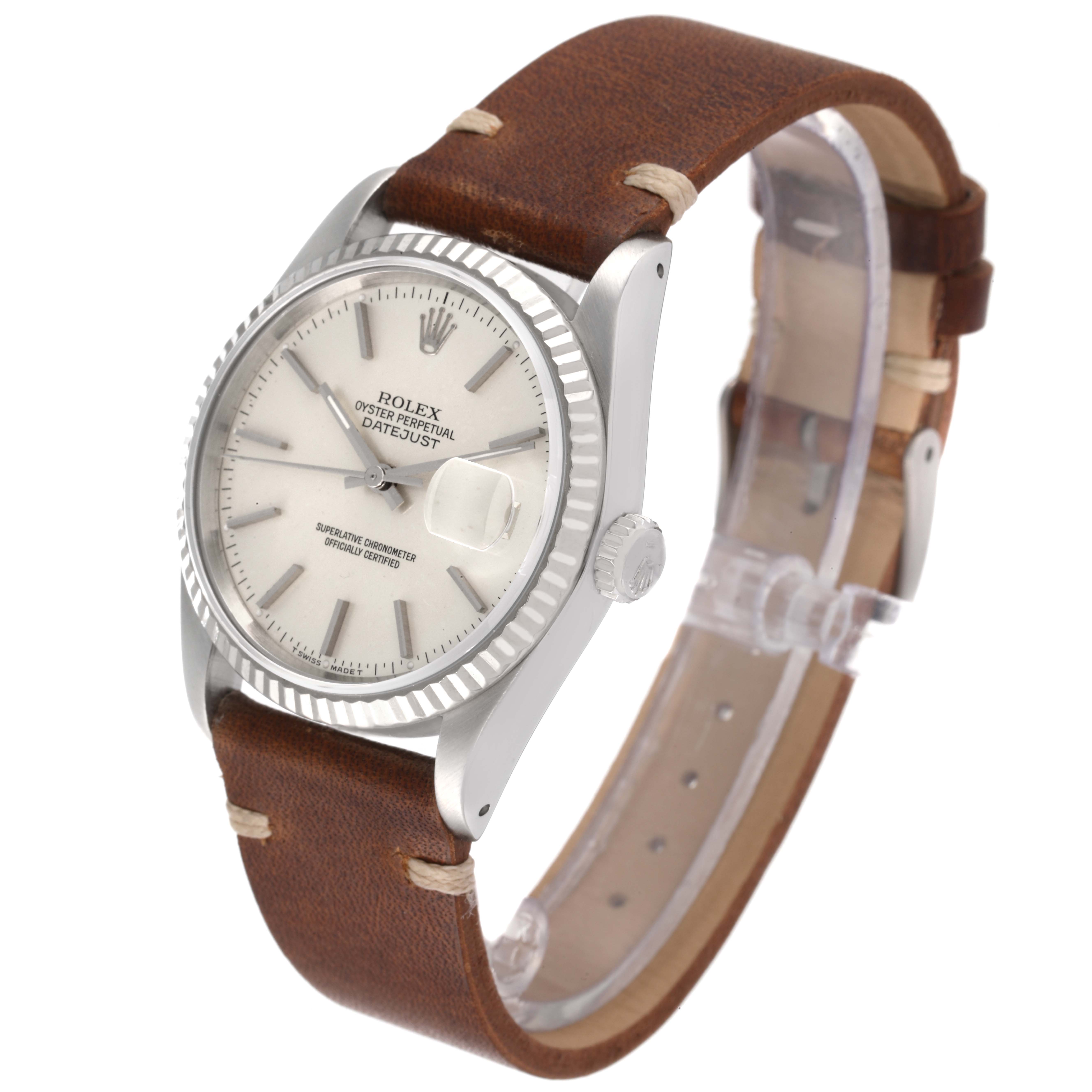 This Rolex Datejust 16234 Men's Stainless Steel Silver Dial 16234 Men's Stainless Steel Silver Dial watch is shown at an oblique angle, highlighting its dial, bezel, crown, and leather strap.