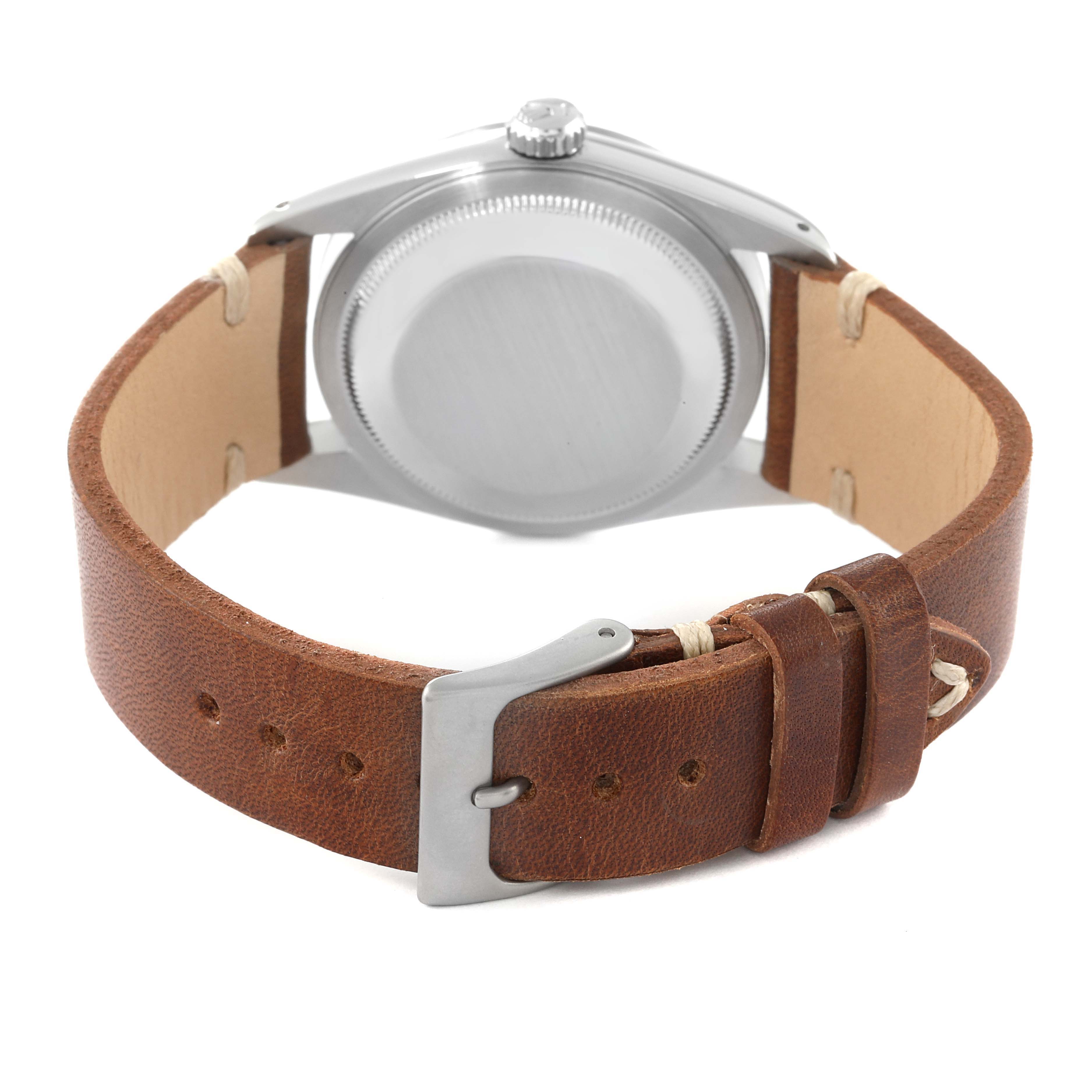 The image shows the back view of a Rolex Datejust 16234 Men's Stainless Steel Silver Dial 16234 Men's Stainless Steel Silver Dial watch with a brown leather strap and buckle.