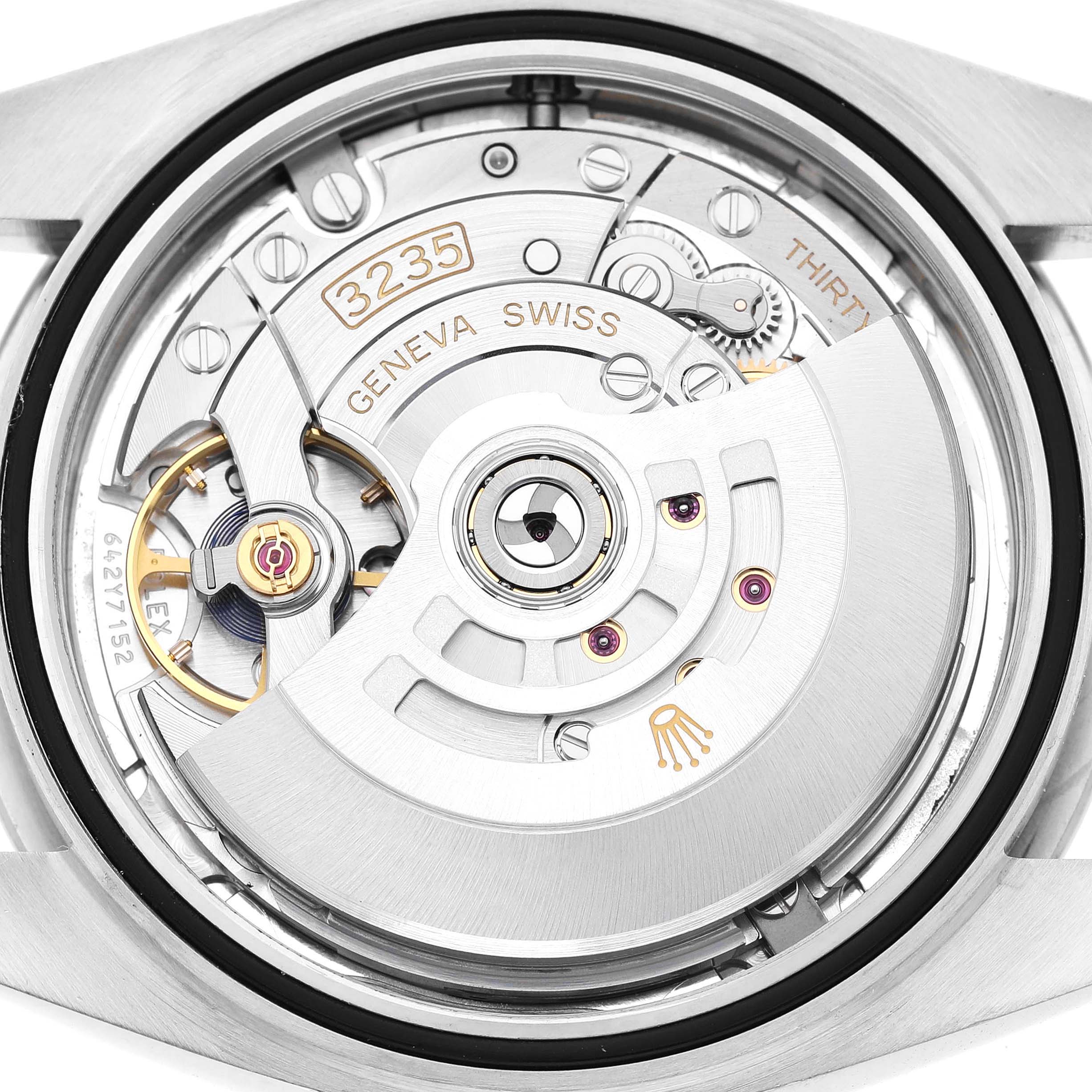 The image shows the movement of a Rolex Datejust 41 126300 Men's Stainless Steel Grey Dial from a back angle, highlighting the intricate gears and rotor.