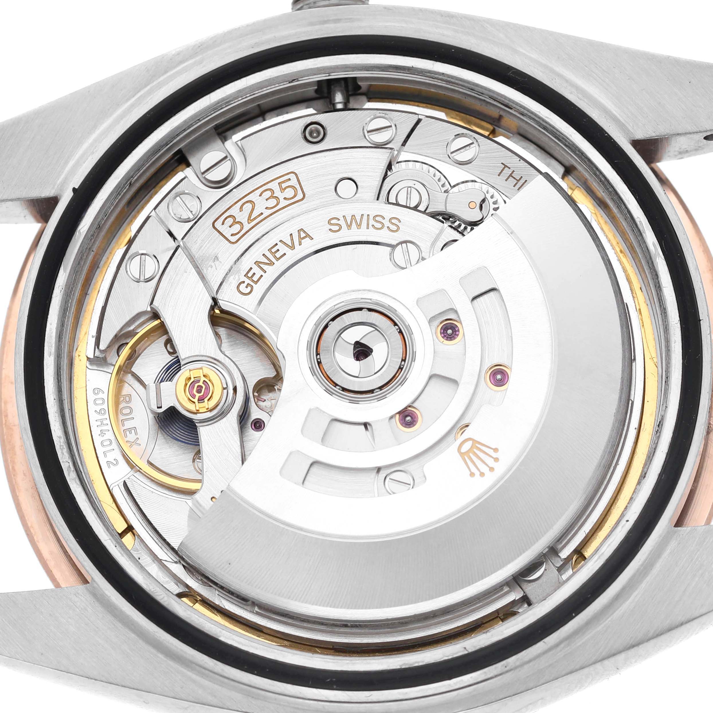 The image shows the movement of a Rolex Datejust 41 126331 Men's Steel and Gold (two tone) Brown Dial, highlighting its intricate inner mechanism from the back view.