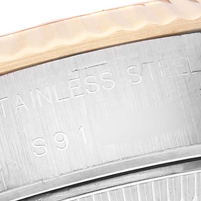 The image shows a close-up of the stainless steel and gold bezel of a Rolex Datejust 69173 Women's Steel and Gold (two tone) Black Dial 69173 Women's Steel and Gold (two tone) Black Dial watch.