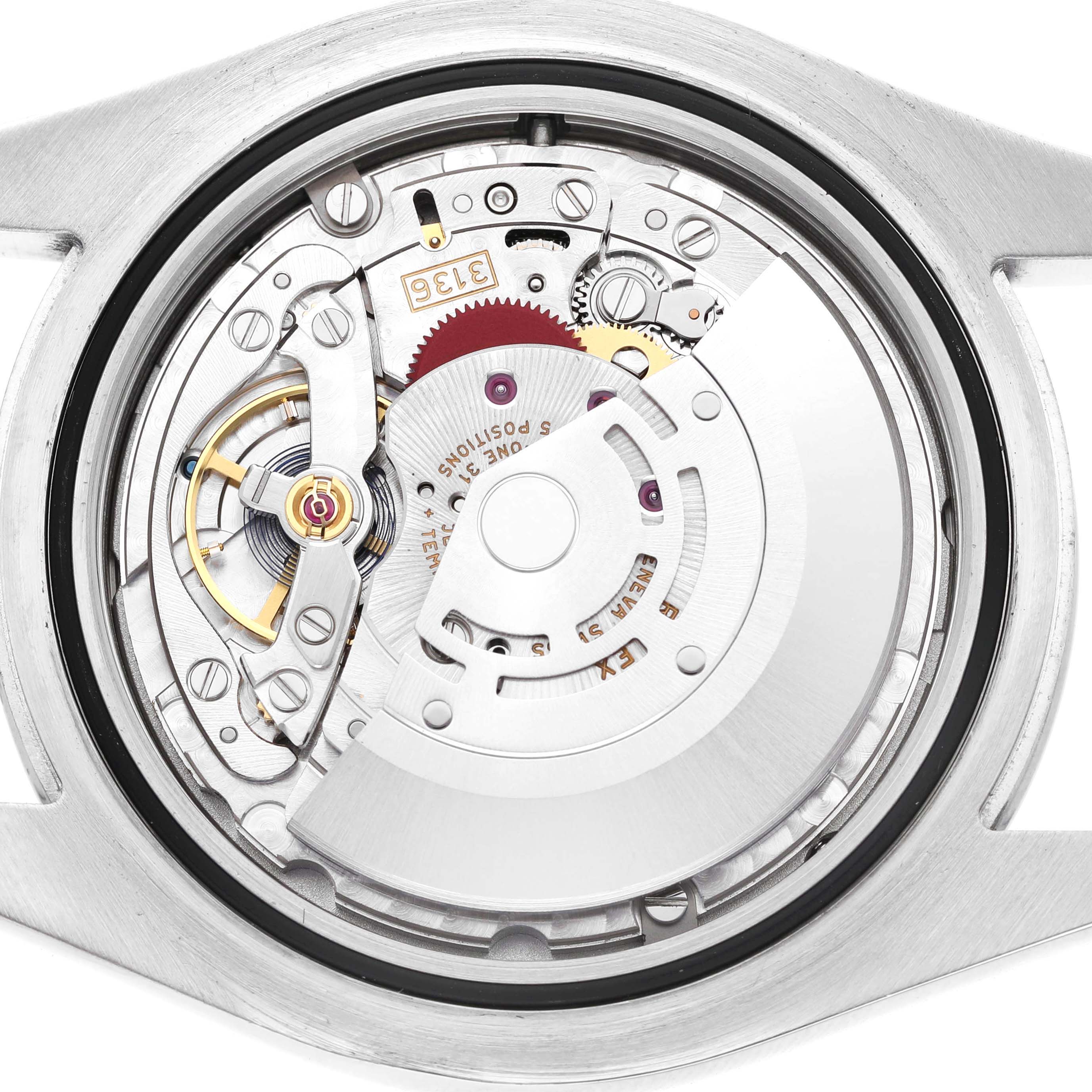 The image shows a close-up of the Rolex Datejust 41 116300 Men's Stainless Steel Blue Dial's movement from a top-down angle, highlighting its intricate mechanical parts.