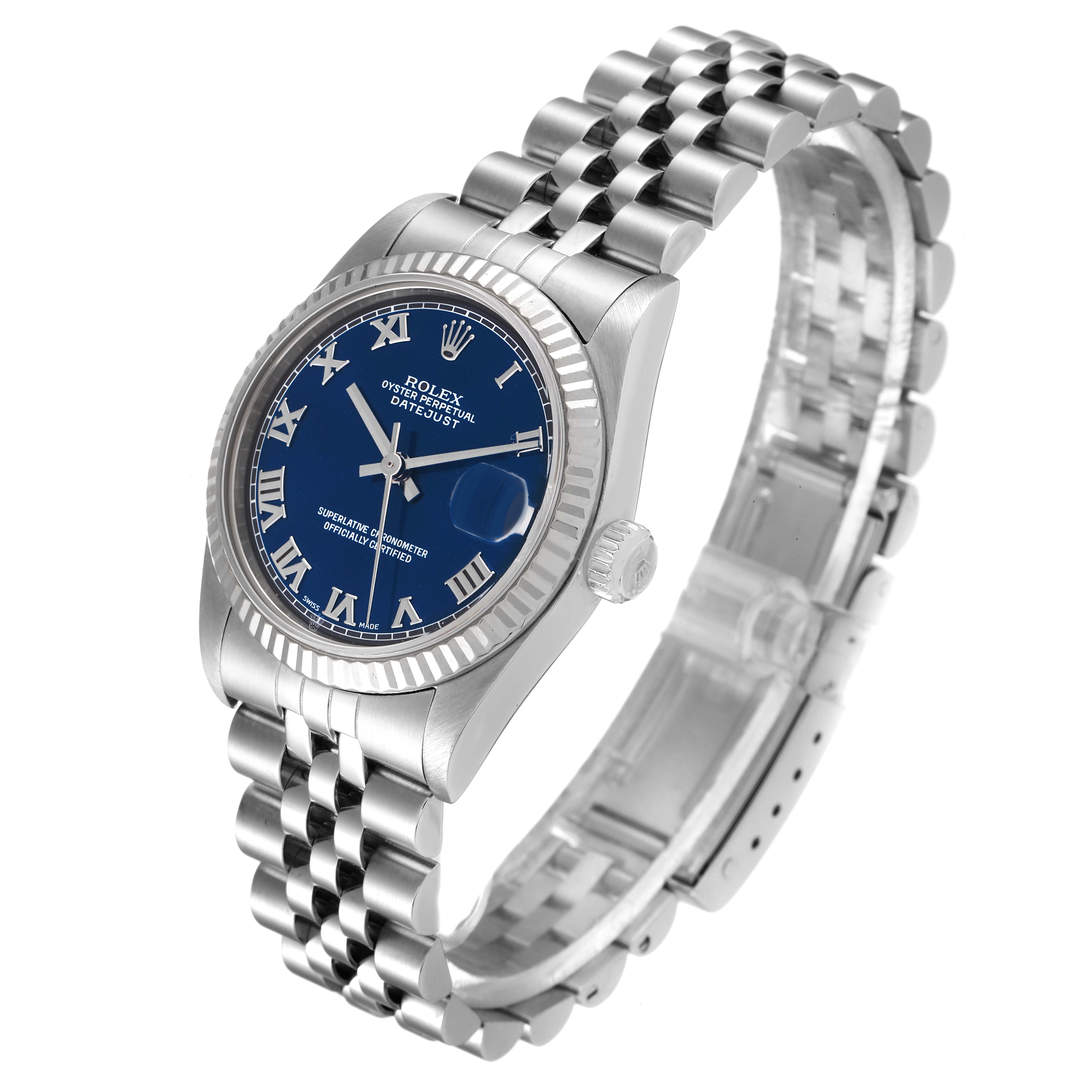 The image shows a Rolex Mid-Size 68274 Women
s Stainless Steel Blue Dial 68274 Women
s Stainless Steel Blue Dial Datejust watch at a three-quarter angle, featuring a blue dial, fluted bezel, and jubilee bracelet.
