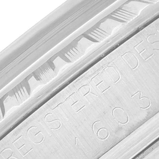 This image shows a close-up of the engraved text and bezel detail on a Vintage Collection Rolex watch.