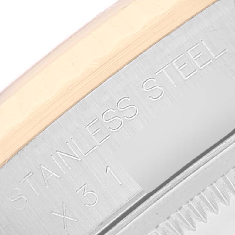 This image shows a close-up angle of the edge and part of the engraving on the case of a Rolex Datejust 16233 Men's Steel and Gold (two tone) Black Dial 16233 Men's Steel and Gold (two tone) Black Dial watch.