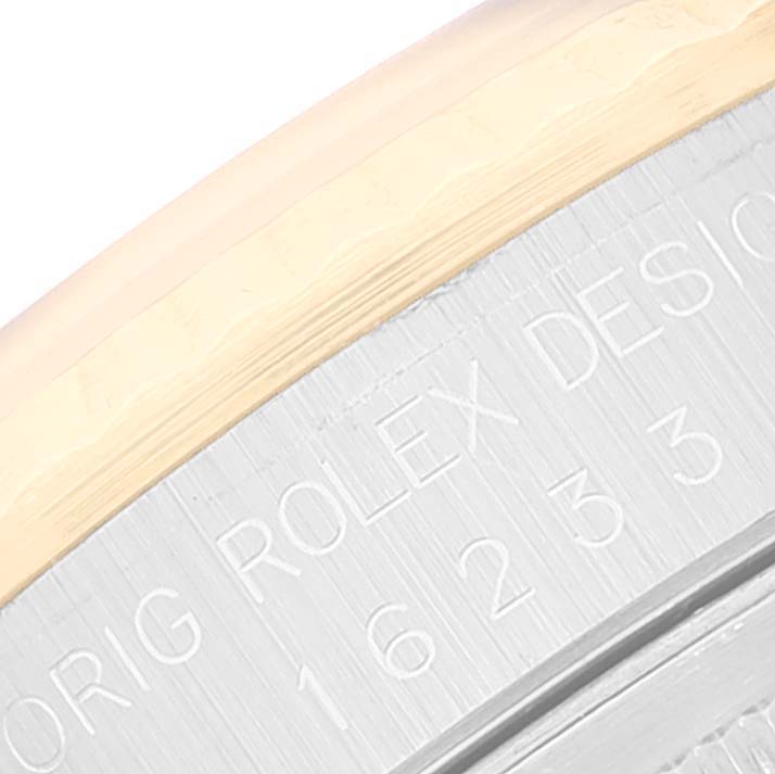 This is a close-up shot of the side of the Rolex Datejust 16233 Men's Steel and Gold (two tone) Black Dial 16233 Men's Steel and Gold (two tone) Black Dial watch case highlighting the model number and part of the bezel.