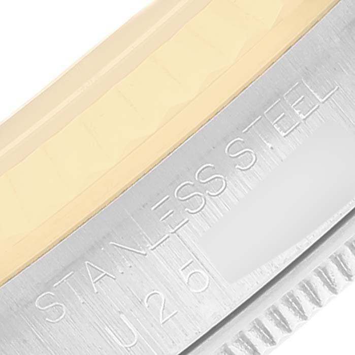 This image shows a close-up of the stainless steel bezel and part of the fluted bezel edge of a Rolex Datejust 16233 Men's Steel and Gold (two tone) Blue Dial 16233 Men's Steel and Gold (two tone) Blue Dial watch.