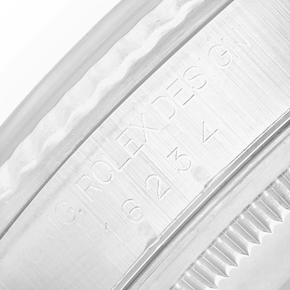 The image shows a close-up of the case edge and reference engraving on a Rolex Datejust 16234 Men
s Stainless Steel Black Dial watch.