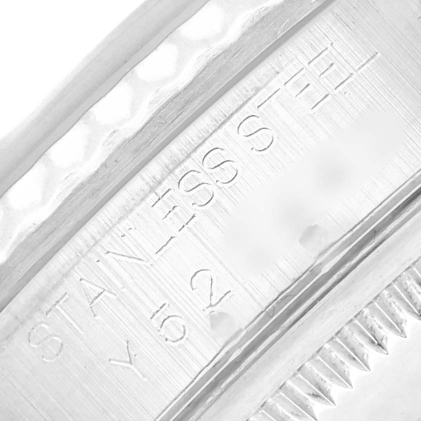 The image shows a close-up of the inner bezel of a Rolex Datejust 16234 Men
s Stainless Steel Black Dial, displaying the "STAINLESS STEEL" engraving.