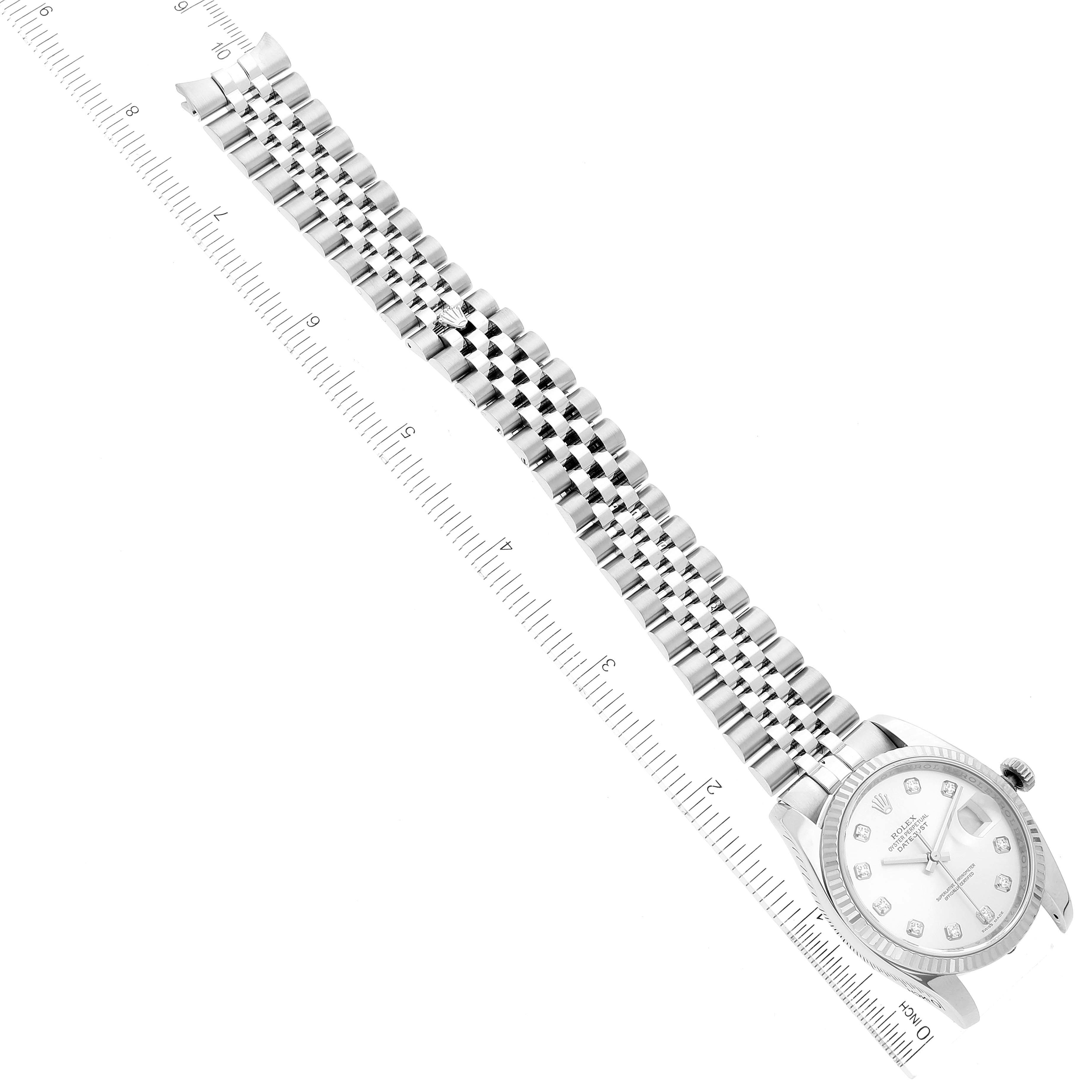 The image displays the Rolex Datejust 116234 Men's Stainless Steel Silver Dial 116234 Men's Stainless Steel Silver Dial watch straightening beside a ruler, showcasing its face and bracelet in a top-down view.