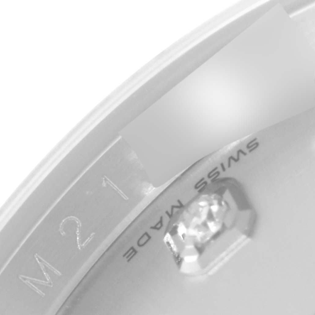 This close-up image of the Rolex Datejust 116234 Men's Stainless Steel Silver Dial 116234 Men's Stainless Steel Silver Dial watch shows the edge of the dial, part of the bezel, and "Swiss Made" text.