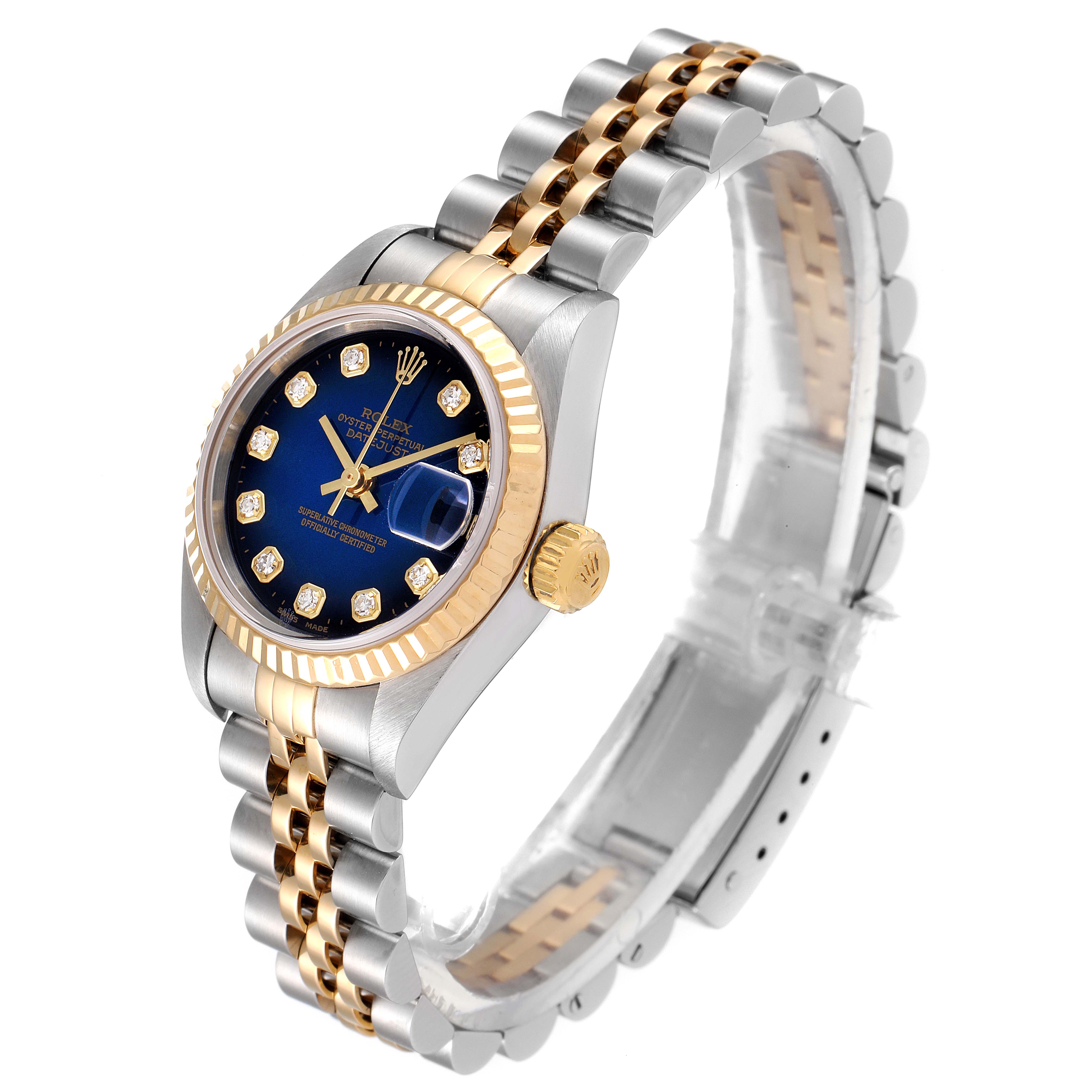 The Rolex Datejust 79173 Women's Steel and Gold (two tone) Blue Dial 79173 Women's Steel and Gold (two tone) Blue Dial watch is shown from a front-right angle, highlighting its dial, fluted bezel, crown, and two-tone bracelet.