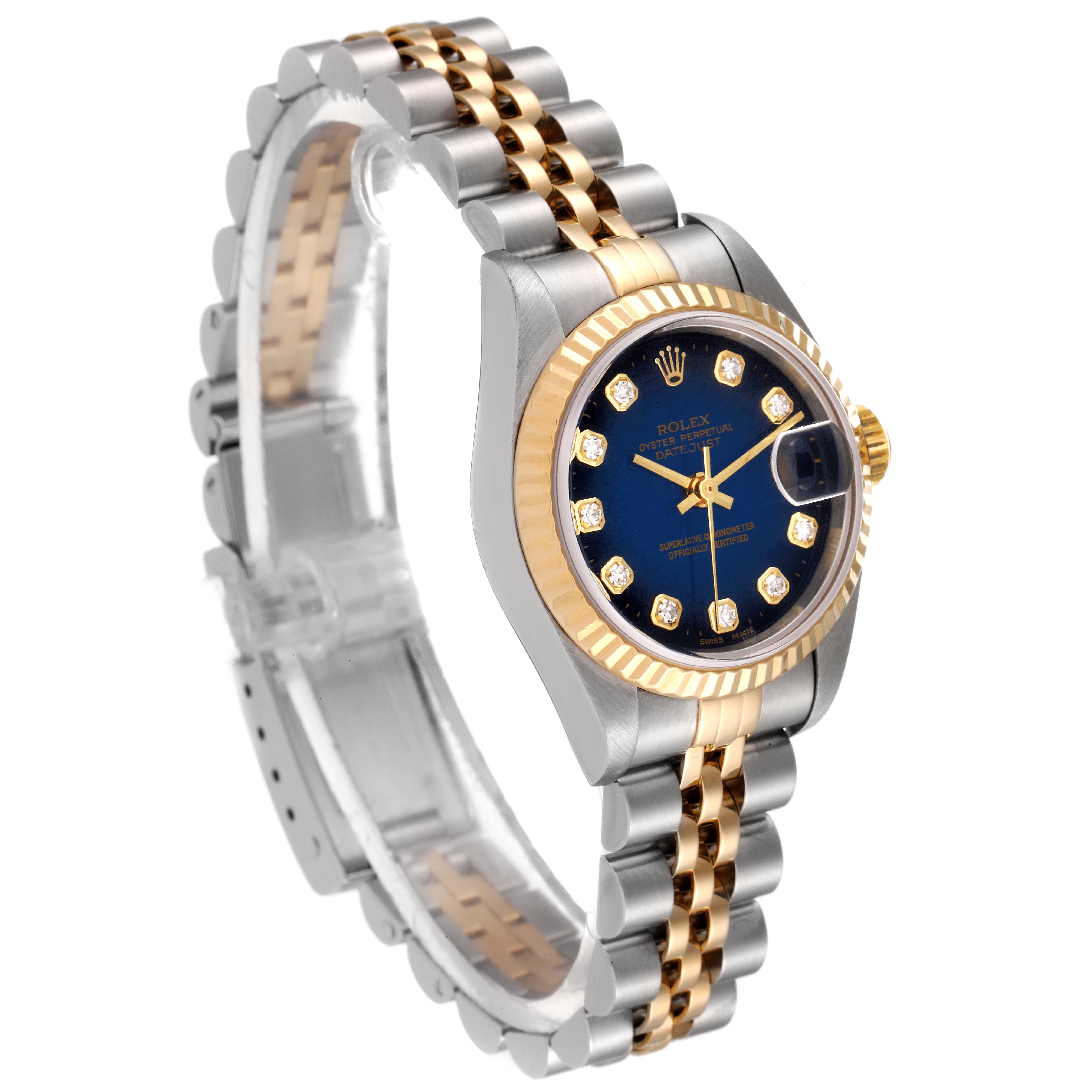 The Rolex Datejust 79173 Women's Steel and Gold (two tone) Blue Dial 79173 Women's Steel and Gold (two tone) Blue Dial watch is shown at an angled side view, highlighting its two-tone bracelet and dark dial with diamond hour markers.