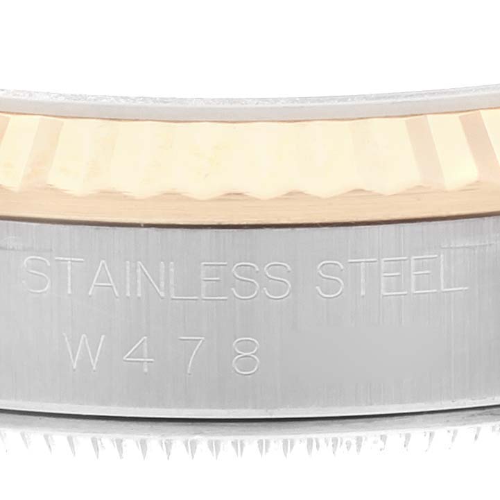 This close-up image shows the side engraving "STAINLESS STEEL W478" on the case of a Rolex Datejust 16233 Men's Steel and Gold (two tone) Champagne Dial 16233 Men's Steel and Gold (two tone) Champagne Dial watch.