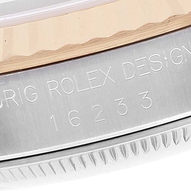 This image shows an angled close-up of the Rolex Datejust 16233 Men's Steel and Gold (two tone) Champagne Dial 16233 Men's Steel and Gold (two tone) Champagne Dial watch model 16233, highlighting the inscriptions on its case.