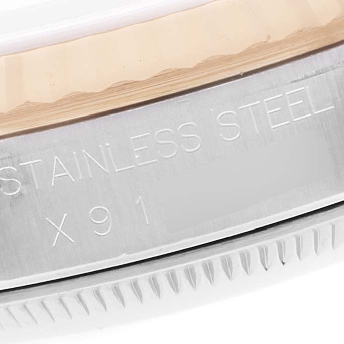 Close-up of the Rolex Datejust 16233 Men's Steel and Gold (two tone) Champagne Dial 16233 Men's Steel and Gold (two tone) Champagne Dial watch showing part of the bezel and the engraved "Stainless Steel" inscription.