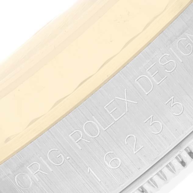 This image shows an angled close-up of the case side of a Rolex Datejust 16233 Men's Steel and Gold (two tone) Champagne Dial 16233 Men's Steel and Gold (two tone) Champagne Dial, including part of the bezel and engraved details.