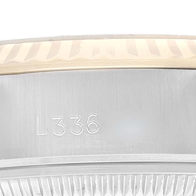 The image shows a close-up of the bezel and part of the case of a Rolex Datejust 69173 Women
s Steel and Gold (two tone) Black Dial 69173 Women
s Steel and Gold (two tone) Black Dial watch, highlighting the engraved serial number.