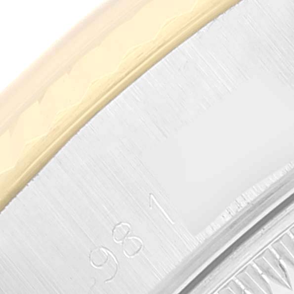 The image is a close-up of the bezel and case side of a Rolex Datejust 69173 Women's Steel and Gold (two tone) Champagne Dial 69173 Women's Steel and Gold (two tone) Champagne Dial watch, showing a portion of the serial number.