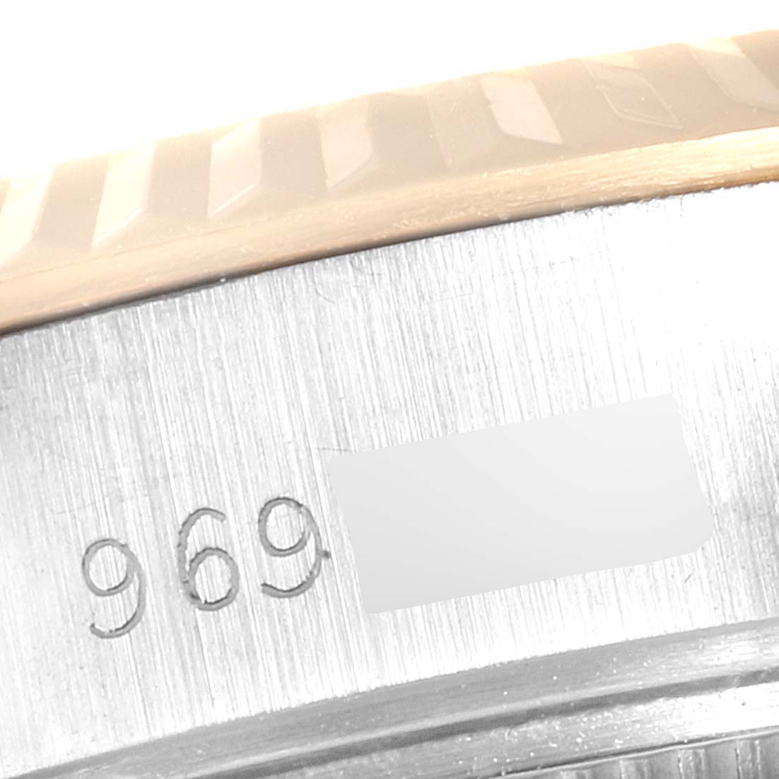 This close-up image shows the serial number engraving on the side of the bezel of a Rolex Oyster Perpetual 69173 Women
s Steel and Gold (two tone) Champagne Dial 69173 Women
s Steel and Gold (two tone) Champagne Dial watch.