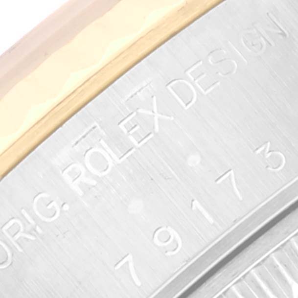 This close-up image shows the engraved side of the casing on a Rolex Datejust 79173 Women's Steel and Gold (two tone) White Dial 79173 Women's Steel and Gold (two tone) White Dial watch.