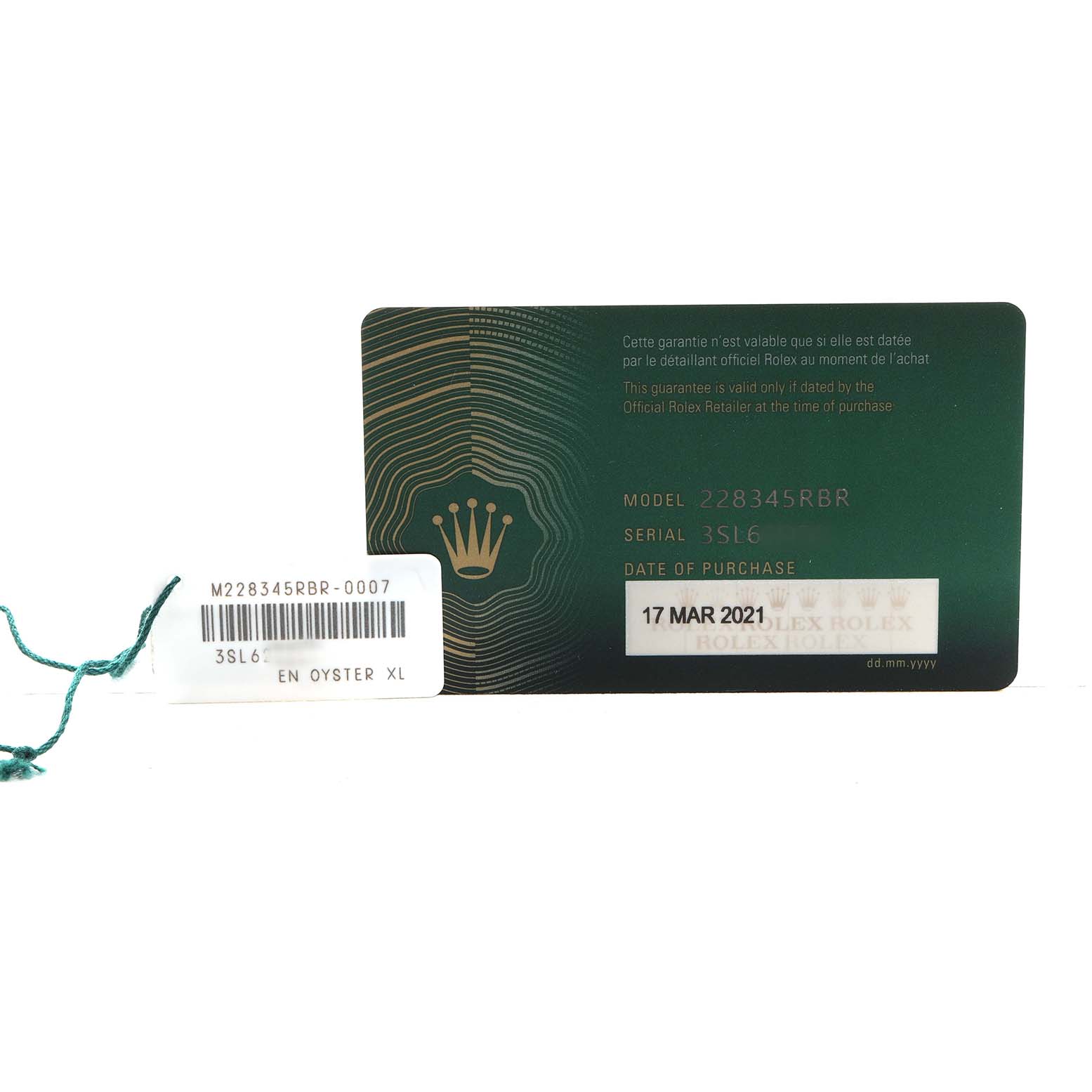 The image shows a green warranty card for a Rolex President 228345 Men's Rose Gold Pink Dial model, along with a serial tag and barcode.