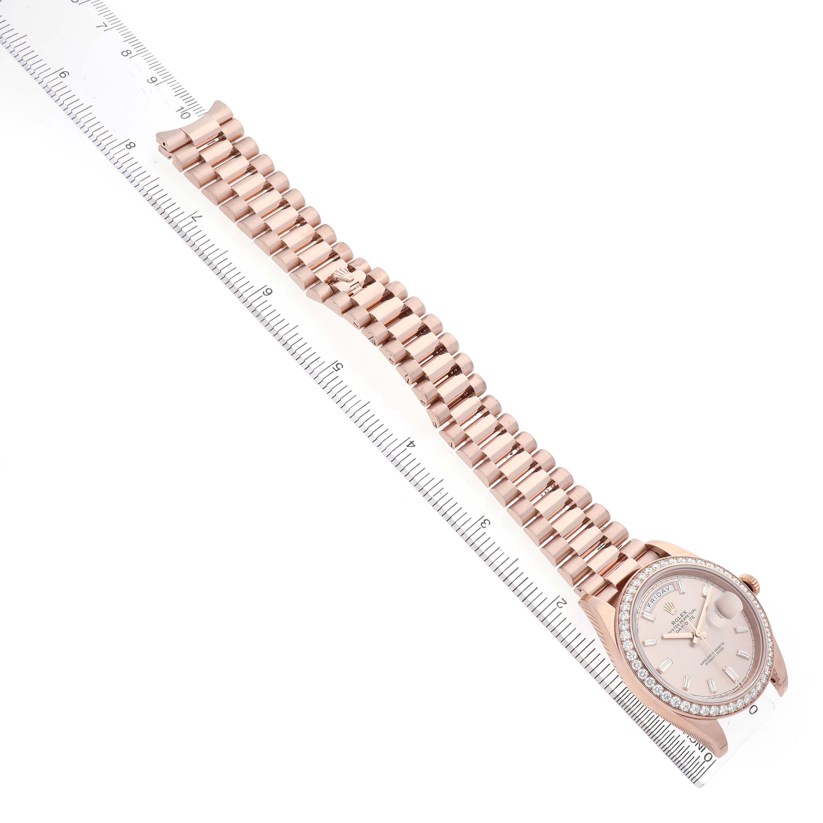 The image shows a Rolex President 228345 Men's Rose Gold Pink Dial model watch, displaying the face and full bracelet with a side angle, alongside a ruler.