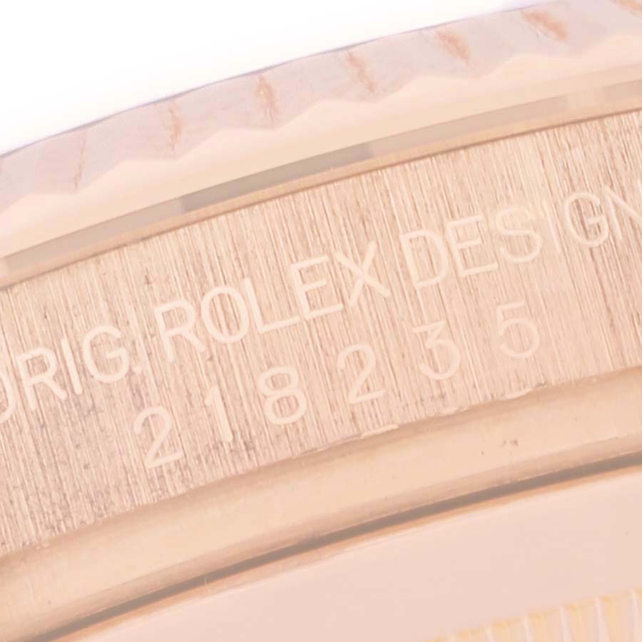 Close-up of the Rolex inscription and serial number on the side of the bezel of a Rolex President 218235 Men's Rose Gold Champagne Dial 218235 Men's Rose Gold Champagne Dial model watch.