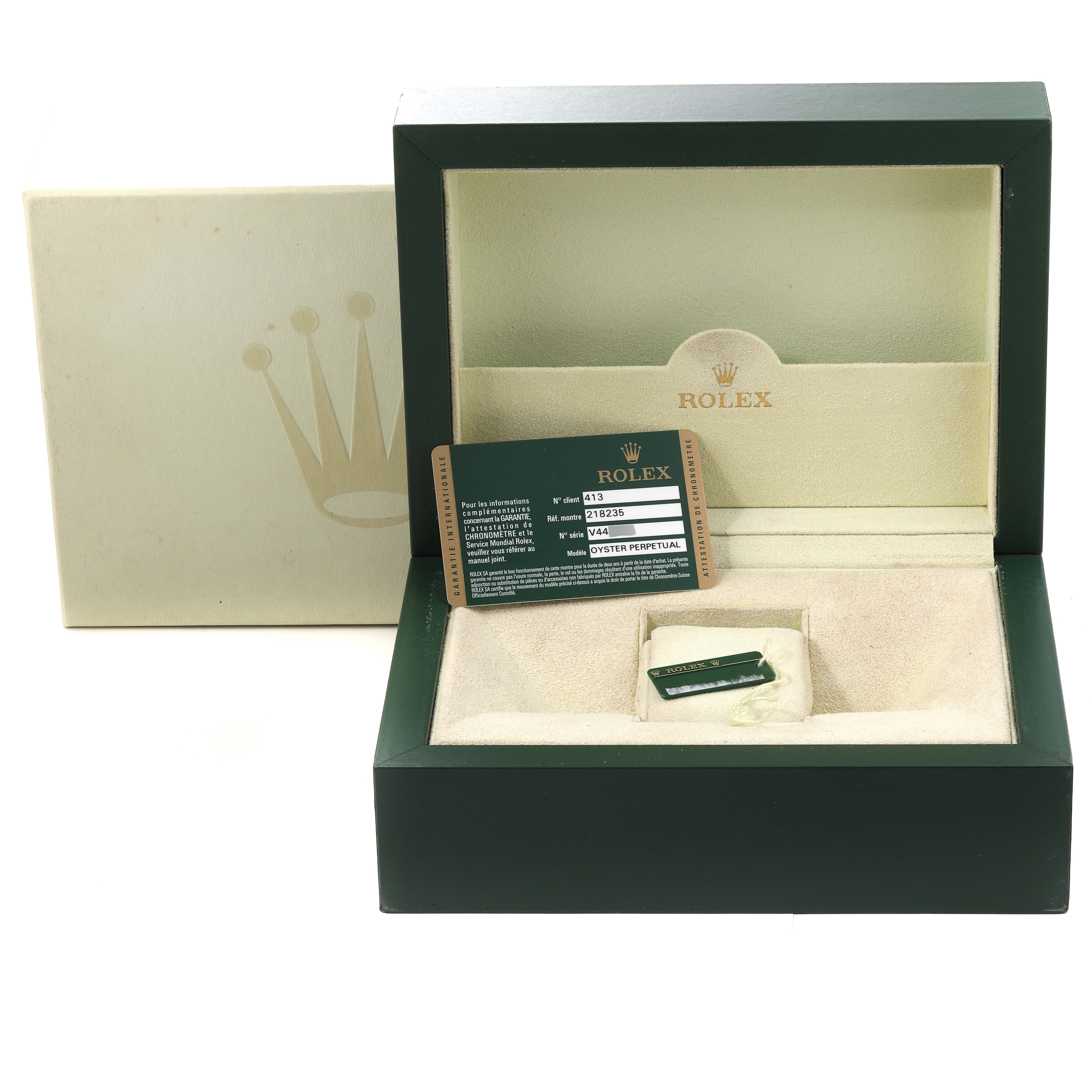 This image shows an open Rolex President 218235 Men's Rose Gold Champagne Dial 218235 Men's Rose Gold Champagne Dial watch box containing a tag and information card.
