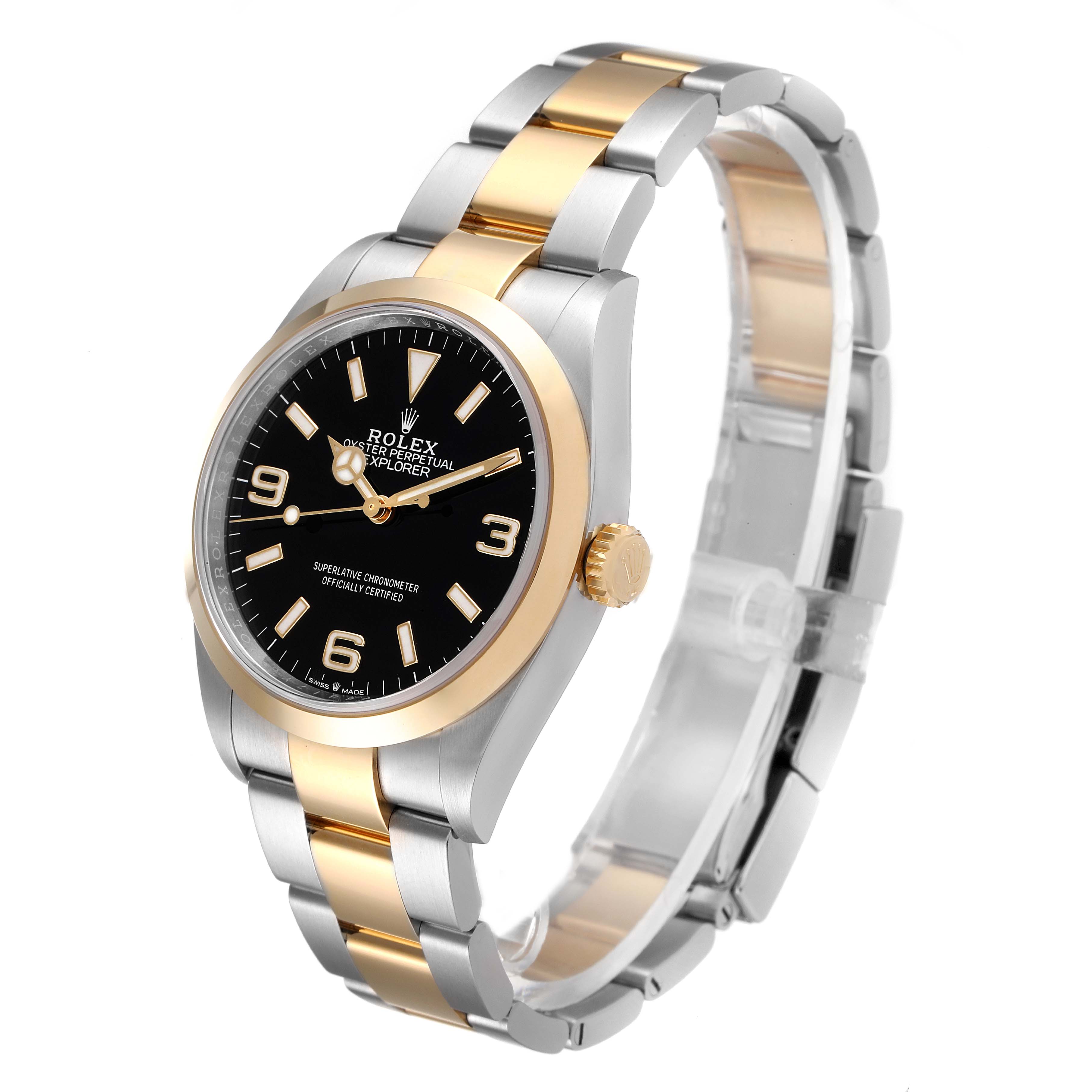 The image shows the front and side of a Rolex Explorer 124273 Men's Steel and Gold (two tone) Black Dial 124273 Men's Steel and Gold (two tone) Black Dial watch, highlighting its black dial, two-tone bracelet, and crown.