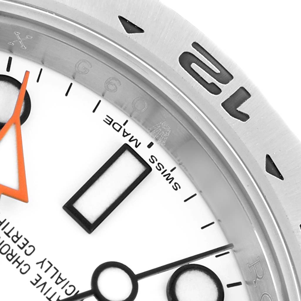 The image shows a close-up of a Rolex Explorer 216570 Men
s Stainless Steel White Dial watch face, highlighting the dial, markers, and part of the bezel.