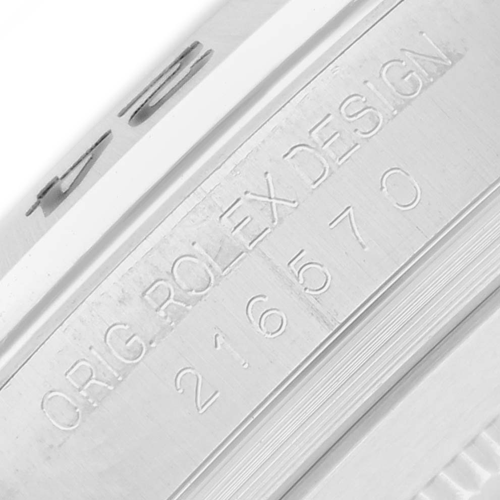 The image shows a close-up of the engraved model number on the inner bezel of a Rolex Explorer 216570 Men
s Stainless Steel White Dial watch.