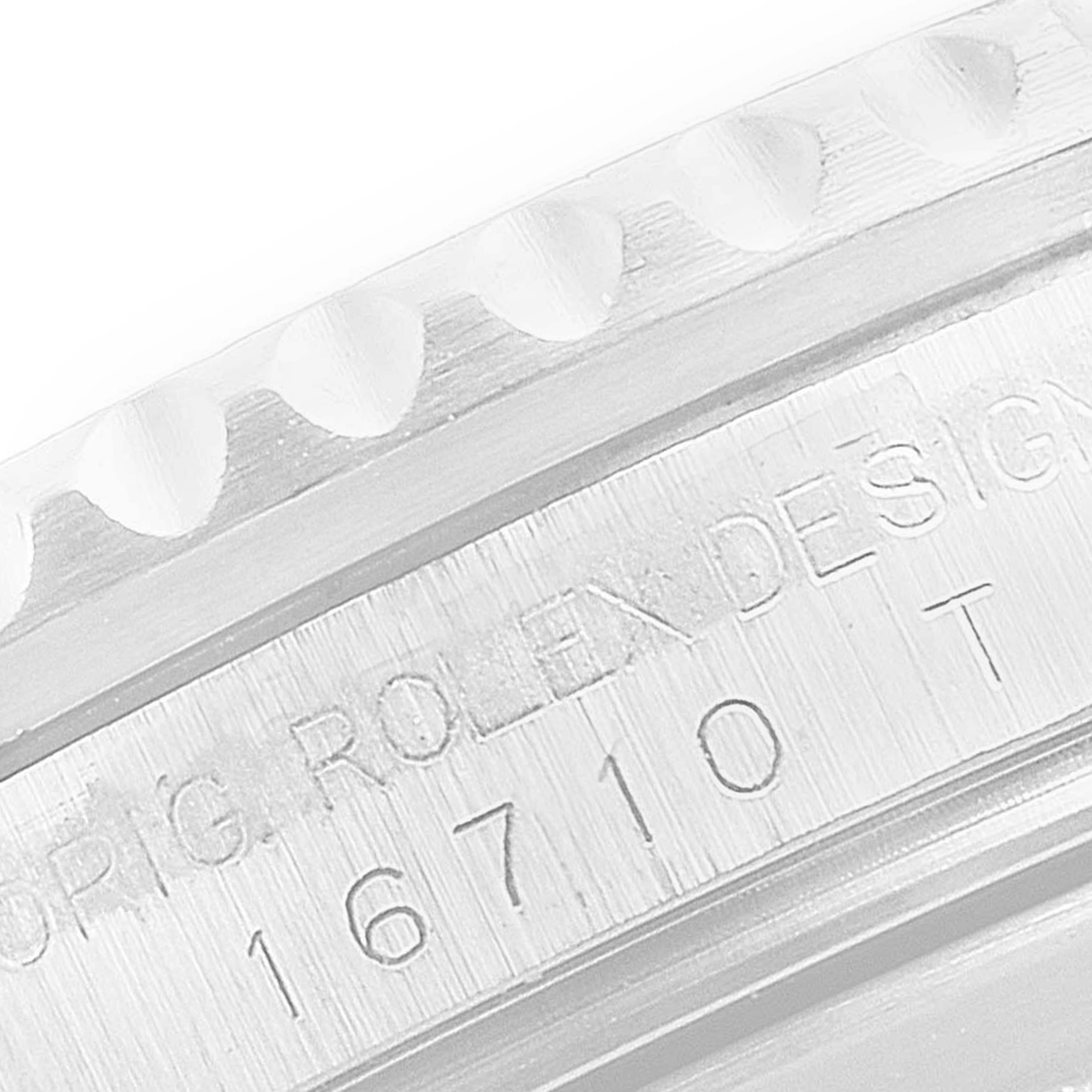 The image shows a close-up of the engraved case and bezel of the Rolex GMT-Master 16710 Men's Stainless Steel Black Dial 16710 Men's Stainless Steel Black Dial model 16710.